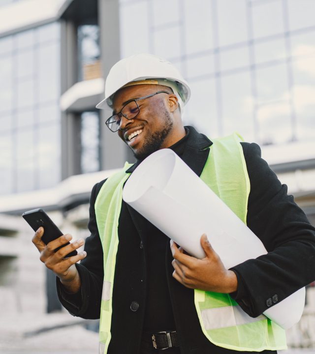 black architect with project talk by phone
